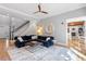 This comfortable living room has a blue sofa and opens to the staircase and fireplace at 1321 Colonial Club Rd, Wake Forest, NC 27587