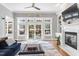 Bright living room with a fireplace and large windows showing the backyard at 1321 Colonial Club Rd, Wake Forest, NC 27587