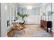 Bright office space featuring wainscotting, a modern chandelier, and hardwood flooring at 1321 Colonial Club Rd, Wake Forest, NC 27587