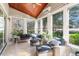 Sunroom with comfortable seating, many windows, and beautiful outdoor views at 1321 Colonial Club Rd, Wake Forest, NC 27587