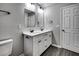 Bright bathroom featuring double sink vanity, white cabinets and wood-look flooring at 1323 Colon Rd, Sanford, NC 27330
