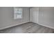 Bedroom featuring gray walls, wood-look flooring, and a window at 1323 Colon Rd, Sanford, NC 27330