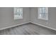 Bedroom featuring gray walls, wood-look flooring, and two windows for lots of natural light at 1323 Colon Rd, Sanford, NC 27330