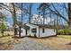 Exterior view featuring fresh landscaping, a gravel driveway, and covered porch at 1323 Colon Rd, Sanford, NC 27330
