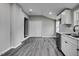 Kitchen featuring white cabinets, stainless steel appliances, gray walls and light gray wood-look flooring at 1323 Colon Rd, Sanford, NC 27330