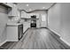 Kitchen with white cabinets, stainless steel appliances, gray walls and light gray wood-look flooring at 1323 Colon Rd, Sanford, NC 27330