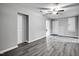 Bright living room featuring gray floors, light neutral walls, ceiling fan and white doors at 1323 Colon Rd, Sanford, NC 27330