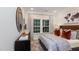 Inviting bedroom with modern decor, a comfortable bed, and a window with curtains at 1502 Red Roses Ave, Durham, NC 27703