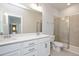 Bathroom featuring a double vanity, large mirror, tile floors, and walk-in shower at 1573 Piney Falls Dr, Wendell, NC 27591