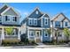 Charming two-story home with light blue siding, a welcoming porch, and a bright yellow front door at 1573 Piney Falls Dr, Wendell, NC 27591