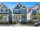 Beautiful two-story home featuring light blue siding, a welcoming porch, and a bright yellow front door at 1573 Piney Falls Dr, Wendell, NC 27591