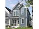 Charming two-story home with blue siding, white trim, covered porch, and well-manicured lawn at 1573 Piney Falls Dr, Wendell, NC 27591