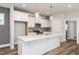 Stylish kitchen featuring an island, white cabinetry, stainless steel appliances, and modern pendant lighting at 1573 Piney Falls Dr, Wendell, NC 27591