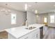 Modern kitchen features an island with a white countertop and stainless steel appliances at 1573 Piney Falls Dr, Wendell, NC 27591