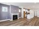Open-concept living room flows into the kitchen, featuring a cozy fireplace and modern finishes at 1573 Piney Falls Dr, Wendell, NC 27591