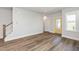 Bright and airy living room with beautiful wood floors, neutral walls, and a staircase at 1573 Piney Falls Dr, Wendell, NC 27591