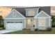 Charming two-story home with a covered entrance, garage, and beautifully landscaped front yard at 165 Big Bradley Dr, Wendell, NC 27591