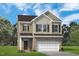 Two-story home featuring a two-car garage, a mix of siding and brick, and a neatly kept lawn at 209 E American Marigold Dr # 44, Benson, NC 27504