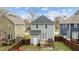 View of the home's backyard featuring a small wooden deck, fenced yard, and exterior access door at 215 Seventh St, Wake Forest, NC 27587