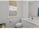 Cozy half bathroom featuring a white vanity with marble countertop at 215 Seventh St, Wake Forest, NC 27587