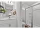 Clean, well-maintained bathroom featuring white vanity, updated fixtures, and a glass-enclosed shower at 215 Seventh St, Wake Forest, NC 27587