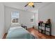 Bright bedroom with natural light from two windows, furnished with a bed and storage unit at 215 Seventh St, Wake Forest, NC 27587
