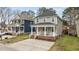 Charming two-story home with a welcoming front porch and well-maintained landscaping at 215 Seventh St, Wake Forest, NC 27587