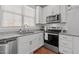 Well-equipped kitchen featuring stainless steel appliances, granite countertops, and shaker-style cabinets at 215 Seventh St, Wake Forest, NC 27587