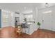 Open concept kitchen with white cabinets, stainless steel appliances, and adjacent dining area at 215 Seventh St, Wake Forest, NC 27587