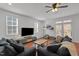 Spacious living room with hardwood floors, ceiling fan, and comfortable seating with easy access to the backyard at 215 Seventh St, Wake Forest, NC 27587