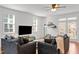 Comfortable living room featuring hardwood floors and stylish furnishings with plentiful natural light at 215 Seventh St, Wake Forest, NC 27587