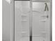 Modern bathroom with sleek, glass-enclosed shower featuring built in shelves and shower head at 215 Seventh St, Wake Forest, NC 27587