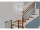 Elegant staircase with wooden banister and ornate iron spindles, adding charm to the home's interior at 215 Seventh St, Wake Forest, NC 27587