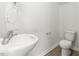 Modern bathroom featuring a sink and toilet with light-colored walls at 279 Canopy Dr, Graham, NC 27253