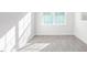 Bright bedroom featuring luxury vinyl floors and a large window at 279 Canopy Dr, Graham, NC 27253