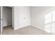 This carpeted bedroom offers a closet for storage at 279 Canopy Dr, Graham, NC 27253