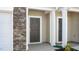Close-up of a front door with stone accents and white trim at 279 Canopy Dr, Graham, NC 27253