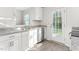 Bright kitchen featuring stainless steel appliances, granite countertops and luxury vinyl flooring at 279 Canopy Dr, Graham, NC 27253