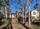 View of a multi-story home from the backyard showcasing the deck, patio, and landscaping at 3005 Woodgreen Dr, Raleigh, NC 27607