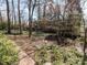 Serene backyard garden with lush greenery and mature trees, offering a peaceful retreat at 3005 Woodgreen Dr, Raleigh, NC 27607