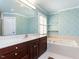 Stylish bathroom featuring unique wallpaper, a soaking tub, and a large vanity at 3005 Woodgreen Dr, Raleigh, NC 27607
