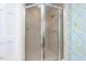 Walk-in shower with glass doors and decorative wallpaper at 3005 Woodgreen Dr, Raleigh, NC 27607