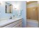 Bathroom with white vanity, mirror, and combination tub and shower at 3005 Woodgreen Dr, Raleigh, NC 27607