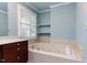 Bathroom featuring a spacious bathtub, large mirror, and decorative wallpaper at 3005 Woodgreen Dr, Raleigh, NC 27607
