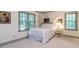 Bright bedroom featuring two windows, plush carpet, and stylish wall art at 3005 Woodgreen Dr, Raleigh, NC 27607