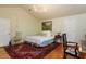 Bright bedroom featuring a decorative rug, Queen bed, and beautiful painting at 3005 Woodgreen Dr, Raleigh, NC 27607