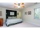 Comfortable bedroom featuring a ceiling fan, neutral carpeting, and decorative wall art at 3005 Woodgreen Dr, Raleigh, NC 27607
