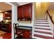 Hallway with staircase, built-in desk, and kitchen access at 3005 Woodgreen Dr, Raleigh, NC 27607