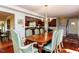 Spacious dining area open to the kitchen featuring hardwood floors and a charming chandelier at 3005 Woodgreen Dr, Raleigh, NC 27607