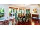 Dining room with hardwood floors and walls of windows overlooking the property at 3005 Woodgreen Dr, Raleigh, NC 27607